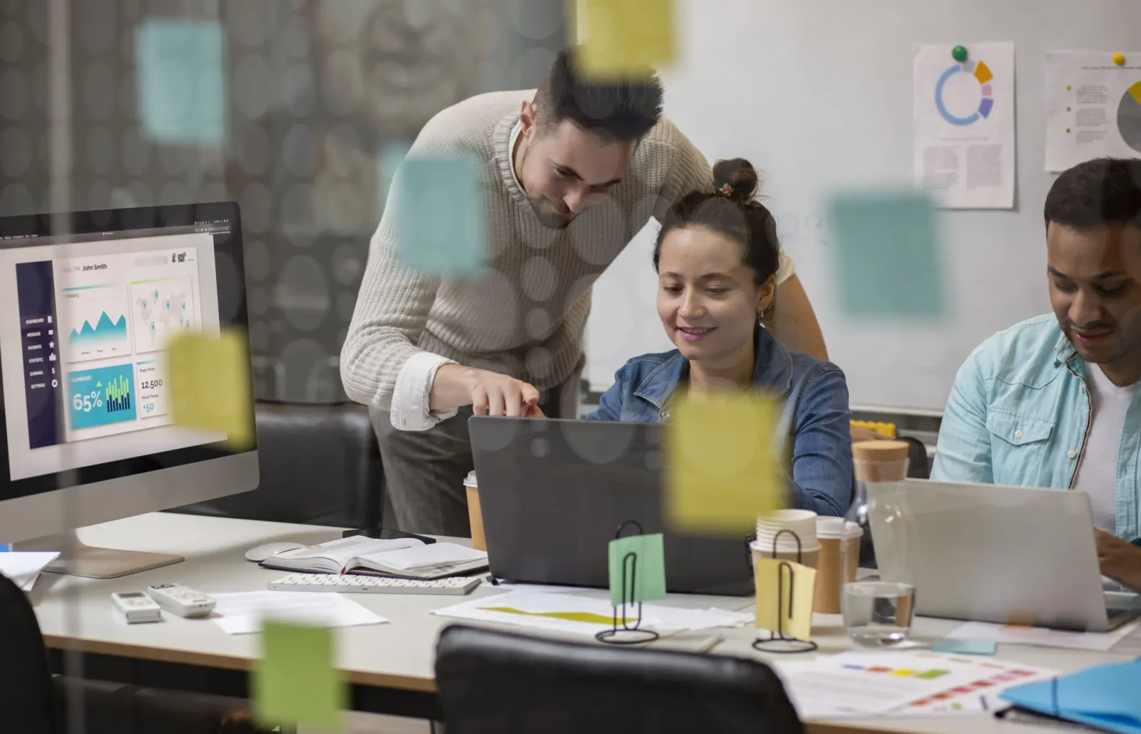 A team reviewing a dashboard on a desktop monitor